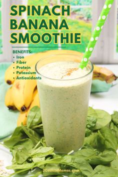 spinach banana smoothie in a glass with a green straw on the side and bananas behind it