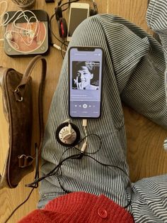 an mp3 player sitting on top of a wooden floor next to other electronics and accessories