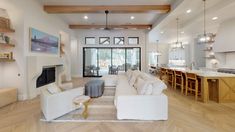 a living room filled with furniture and a fire place in the middle of a kitchen