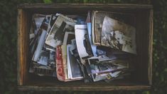 a wooden box filled with lots of newspapers