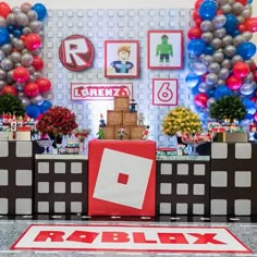 a room decorated with balloons and pictures on the wall for roblox's birthday party