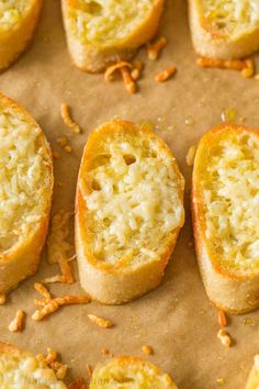 several pieces of bread that are sitting on a piece of parchment paper with nuts scattered around them