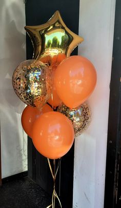 orange and gold balloons in front of a black door