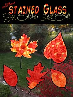 stained glass sun catchers with fall leaves on them in front of a lawn and flowers