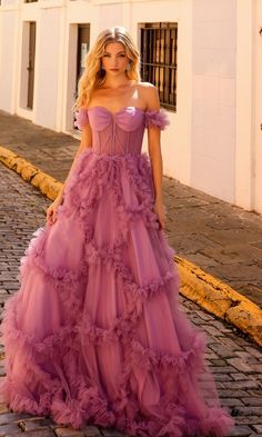 Here's an off-the-shoulder long lavender prom ball gown that is as flirty as it is feminine. With a sheer corset-style bodice that wraps around to the back and ruffled banded sleeves that drape over the upper arms, this long lavender formal dress was made for romance. In misses and some plus sizes, this sweet long evening gown has a fully-lined long skirt with ruffled geometric designs that showcase a real southern feel. A look of romance with a southern feel, this off-the-shoulder long lavender Ballgown Prom Dress Corset, Ball Gown For Prom, Lavender Formal Dress, Prom Dress With Corset, Long Ball Gown, Sheer Corset, Dusty Lavender, Corset Boning, Off Shoulder Gown