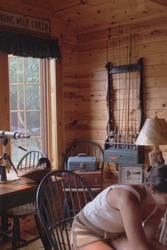 Girl leaning over table playing cards in wooden walled cabin Old Cabin Aesthetic, Lake Cabin Aesthetic, July Reset, Vermont Photography, Writers Retreat, Tahoe Cabin, Lana Del Rey Albums, Cabin Vibes, Hippie Cowgirl