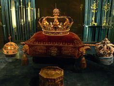 an elaborately decorated bed with gold crown on top