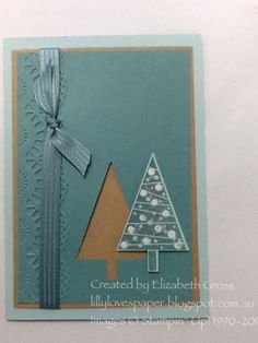 a handmade christmas card with a tree on it's side and ribbon around the corner