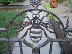 a metal fence with a bee design on it