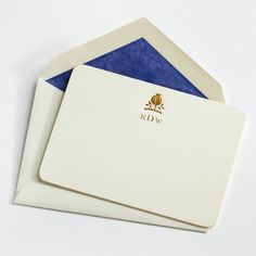 two envelopes with blue and white paper on the inside one has a gold logo