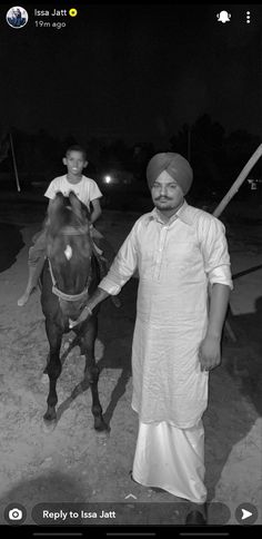 a man is standing next to a horse