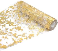 a roll of gold glitter tape sitting on top of a white surface with yellow sprinkles