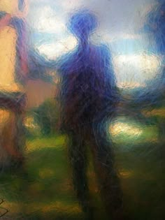 blurry photograph of two people standing in front of a window with the sun shining on them