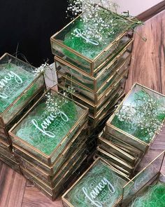 a stack of wooden boxes filled with green grass and white baby's breath flowers