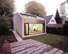 a modern house with an open patio and sliding glass doors