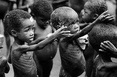 black and white photograph of children playing with each other