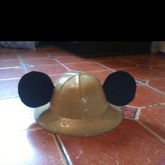 a mickey mouse hat sitting on top of a tiled floor