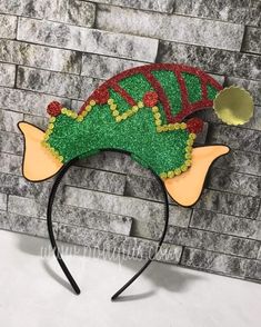 a green and red headband on top of a brick wall