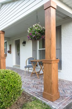 the front porch is covered with plants and chairs