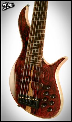 a close up of a bass guitar with an intricate design on the body and neck