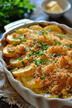 a casserole dish with potatoes and parmesan cheese on the top is ready to be eaten