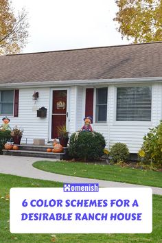 a white house with pumpkins on the front lawn