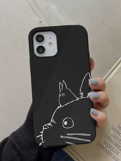 a person holding up a phone case with a cat on it