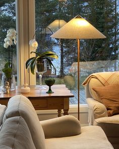 a living room filled with furniture and a large window