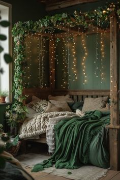 a bed with green sheets and lights on the headboard is in front of a window