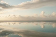 the reflection of clouds in the water is very clear and blue with no one on it