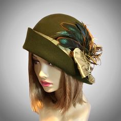 This beautiful Loden/Olive colored ladies cloche is made from fur felt, and hand draped over an antique hat block. This hat is embellished with a silk dupioni sash, and feathers.  I personally create each hat one at a time, and no two are ever exactly the same.  My hats are 100% handmade for you using traditional Millinery techniques and the highest quality fabrics and details.  Please allow 2-3 weeks before shipping, unless otherwise agreed upon. Please indicate your head size measurement when Art Hats, Loden Green, Cloche Hats, Flapper Hat, Silk Dupioni, Hat Blocks, Antique Hats, Millinery Hats, Antique Brooches