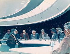 a group of people sitting at a table in front of a ceiling with stars on it