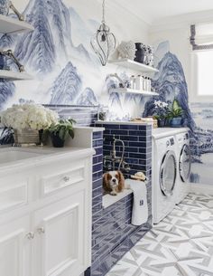 a laundry room with blue and white wallpaper