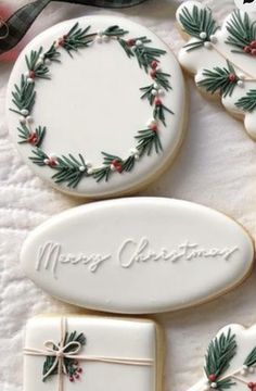 christmas cookies decorated with holly and pine branches