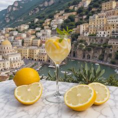 two lemons and one lime sit on a table in front of a view of the city