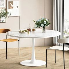 a white table and two chairs in a room