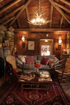 a living room filled with furniture and a fire place under a chandelier hanging from the ceiling