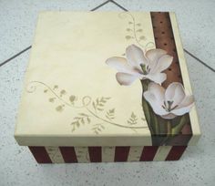 a box with flowers painted on it sitting on the floor