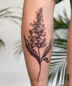 a black and white flower tattoo on the leg