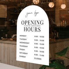 an open hours sign hanging from the side of a window in front of a restaurant