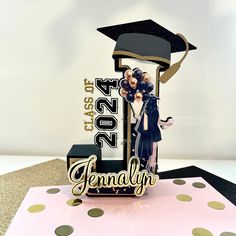 a graduation cake topper with an image of two people on it