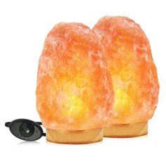 two orange himalayan salt lamps sitting next to each other