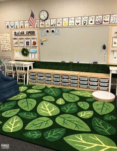 a classroom with green rugs and chairs