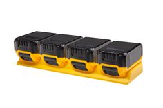 three black and yellow batteries are on a stand with four other battery holders in the background