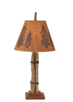 a lamp that is made out of wood and has pine trees on the side of it