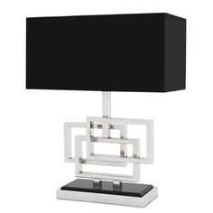 a black and white table lamp with a square shade on it's base, against a white background