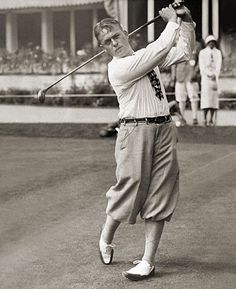 an old black and white photo of a man playing golf