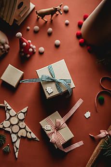 christmas presents are laid out on the floor next to other ornaments and decorations, including an ornament