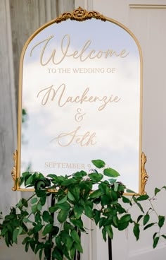 a welcome sign sitting next to a potted plant