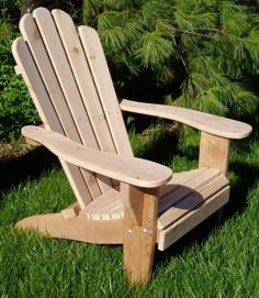 a wooden lawn chair sitting in the grass